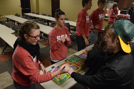 Nicole Haynes, junior psychology major, stamps Andrew Cox, sophomore music major, as he gets refreshments during the movie in the Bowld Student Commons sponsored by the Student Government Association.  - Photo by Anne Richoux