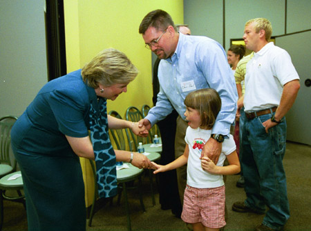 First Lady Lanese Dockery greets Mathematics Professor Chris Hail and his daughter at the President's Reception. - Photo by Jim Veneman