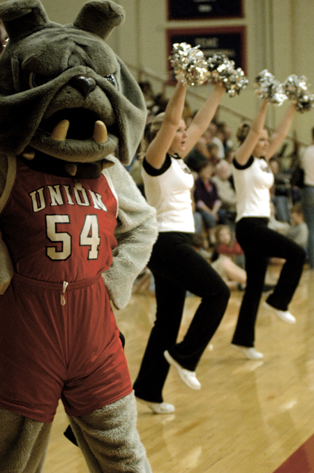 Buster the Bulldog joins forces with the cheerleaders and the home crowd during basketball games. He can be found roaming around the gym, rousing the crowd and playing with children. - Photo by Lindsay Stavish