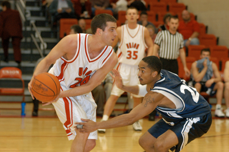 Senior guard Will Harris (24) looks for help during a game with Berry College. - Photo by Kristen Hiller