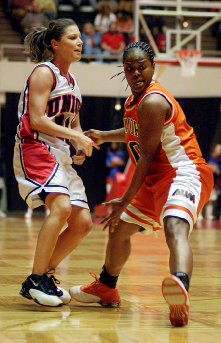 Jennifer Henson (11) gets a pass away despite tough defense from an Auburn-Montgomery player during the NAIA National Tournament. - Photo by Kristen Nicole Sayres