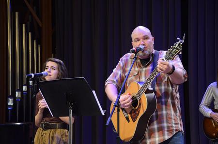 Russ Pflasterer, pastor of City Fellowship, leads music before Taylor Worley speaks in chapel. - Photo by Zac Calvert