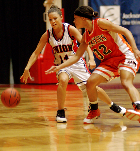 Sophomore guard Jennifer Henson (11) keeps the ball from an Auburn-Montgomery defender. - Photo by Kristen Nicole Sayres