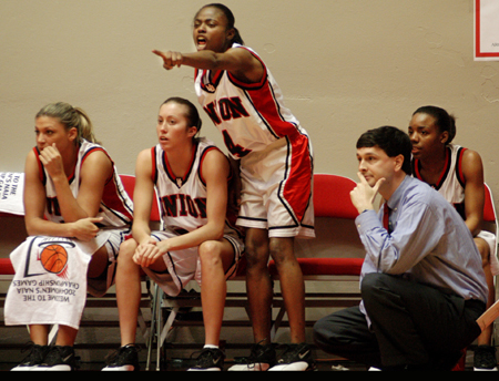 Head coach Mark Campbell watches the game as the players help their teammates from the bench. - Photo by Kristen Nicole Sayres