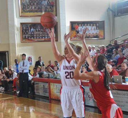Under the watchful eye of Coach Campbell Union's Amy Philamlee gets the shot off under pressure from Saint Xavier. - Photo by Morris Abernathy