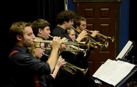Chase Techentin, senior music major, plays trumpet alongside other members of the Jazz Band during a concert held in the W.D. Powell Theatre. - Photo by Jacob Moore
