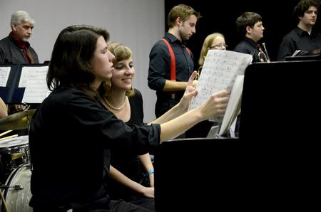 Pianists Brandon Swing, sophomore music major, and Anna Lewis, sophomore TESL major, prepare their sheet music during the Fall 2011 Jazz Band Concert. - Photo by Jacob Moore
