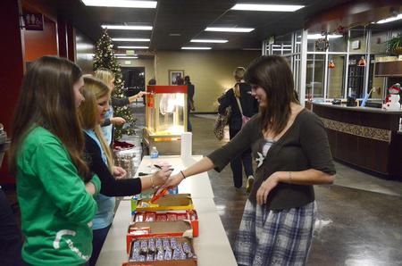 Maggie Ledbetter, senior physical education and health major, picks up some candy during Sac's Movie in the Bowld.  - Photo by Zac Calvert