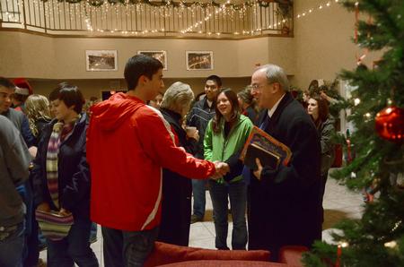 David S. Dockery, president of the university, greets students as they leave McAfee Commons after being read the Christmas story.  - Photo by Ebbie Davis