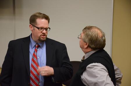Hunter Baker, associate professor of political science, speaks to Michael Chute, professor of communication arts, at the Town & Gown lecture series. - Photo by Zac Calvert