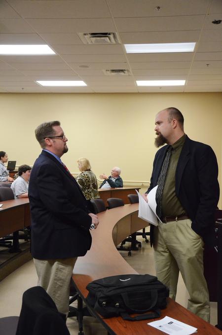Hunter Baker, associate professor of political science, and Micah Watson, assistant professor of political science, chat in between Town & Gown sessions. - Photo by Zac Calvert