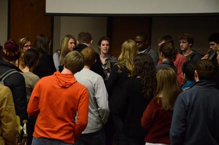 Kylie McDonald, junior political science major, talks with Student Senate members following a senate meeting. - Photo by Anne Richoux