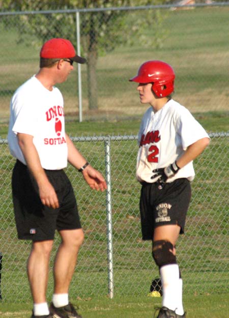 Union head coach Brian Dunn talks with the baserunner, Allison Shein from the third base coach's box. - Photo by Heidi Davis