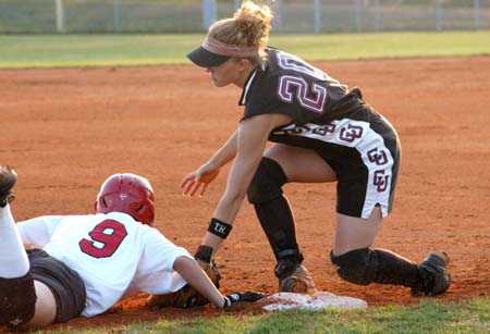 Christina Johnson (9) slides around to tag to reach third base safely. - Photo by Heidi Davis