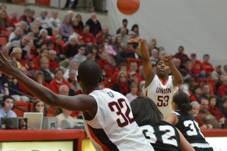 Lavanda Ross passing the ball to teammate Mildred Olumasi. - Photo by Morris Abernathy