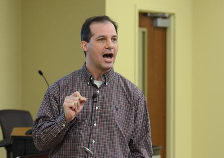 Sean Evans, associate professor and chair of the department of political science, speaks at the Town & Gown lecture series. - Photo by Jacob Moore