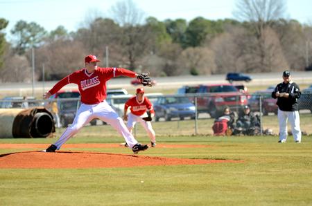 Colin Hatch pitches to a Taylor University player during a double-header. The Bulldogs won both games on Saturday.  - Photo by Anne Richoux