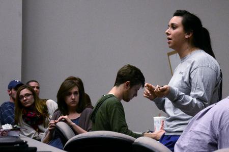 Meredith Gunn, senior business administration major, tells students about upcoming SGA events during Student Senate meeting. - Photo by Anne Richoux