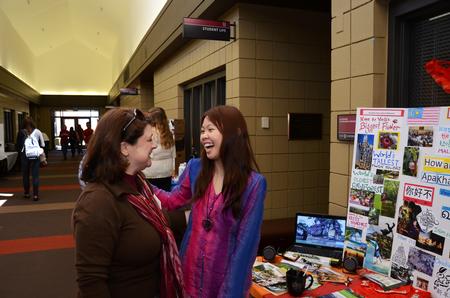 Victoria Malone, instructor of language, laughs with Kendra Loh, sophomore psychology major, during CultureFEST. - Photo by Zac Calvert