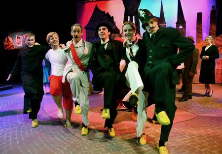 Cast members form a chorus line during the closing scene of The Union University Players' production of Friedrich Dürrenmatt's <em>The Visit</em> in the W.D. Powell Theatre. - Photo by Jacob Moore