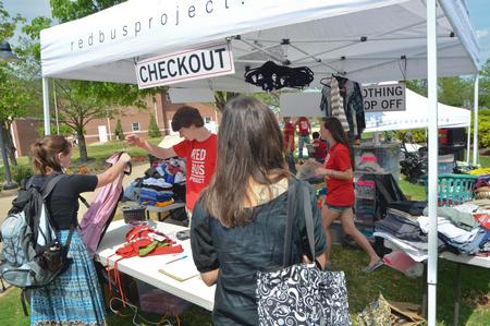 The big red bus stopped at Union University April 3 and offered Union students an opportunity to donate clothes, buy clothes that had been previously donated and interact with Chapman and other representatives from the Red Bus Project.   Students check out after picking out some clothing from the bus. - Photo by Morris Abernathy