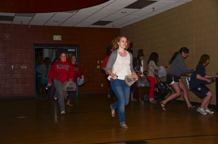 Caitlyn Miller, sophomore art major, Melissa Fields, junior business administration major, and Rachel Emanuel, sophomore TESL major, rush into the Bowld Student Commons for Eggstravaganza, an event hosted by Residence Life. - Photo by Zac Calvert