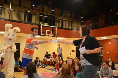 Luka Perkovic, sophomore business administration major, is presented a giftcard from Ashley Jackson, resident director, during Eggstravaganza. - Photo by Zac Calvert