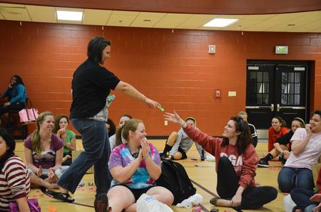 Ashley Jackson, resident director, gives Kylie McDonald, junior political science major, a giftcard after she won a prize during the Residence Life Eggstravaganza event. - Photo by Zac Calvert