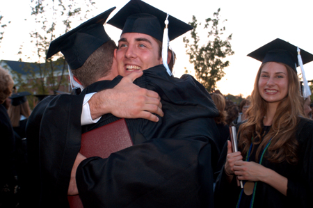 Biblical studies graduate Nicholas Ellis hugs a fellow graduate shortly after commencement exercises on Saturday, May 22. Tigrett Award winner and public relations graduate Laura Lee Moore is pictured to the right. - Photo by Kristen Nicole Sayres
