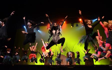 Members of the independent group "Once Upon a Time" leap into the air during their performance at the 15th annual Variety Show. - Photo by Jacob Moore