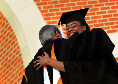 Director of Career Services Jacqueline Taylor is hugged by President Dockery shortly after receiving her Master of Arts in Education degree at spring commencement. - Photo by Jonathan Blair