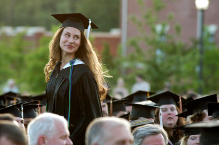 Public relations graduate Laura Lee Moore makes her way to the podium to accept the Tigrett Award at spring commencement. - Photo by Kristen Hiller
