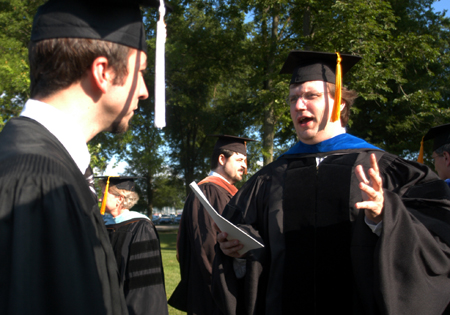 Digital Media Studies Coordinator Chris Blair (right) speaks with Digital Media Studies graduate Jonathan Miller shortly before spring commencement. - Photo by Kristen Nicole Sayres