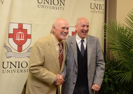 Terry Bradshaw, keynote speaker, poses with Steve Beverly, associate professor of communication arts, after the fourth annual Roy L. White Legacy Golf & Gala. - Photo by Jacob Moore