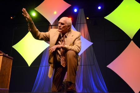 Terry Bradshaw, former NFL quarterback and current FOX Sports analyst, kneels to emphasize an important part of a story while speaking at the Roy L. White Legacy Golf and Gala.   - Photo by Ebbie Davis