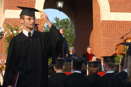 Pychology graduate Jesse Florida ceremonially shifts his tassle during spring commencement. - Photo by Kristen Nicole Sayres
