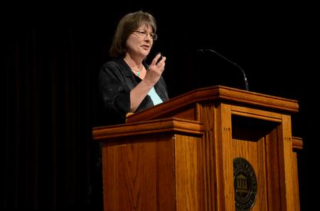 Mary Ann Poe, professor of social work and BSW program director, uses a pedometer as an illustration as she speaks about the importance of following in the steps of Jesus.  - Photo by Anne Richoux