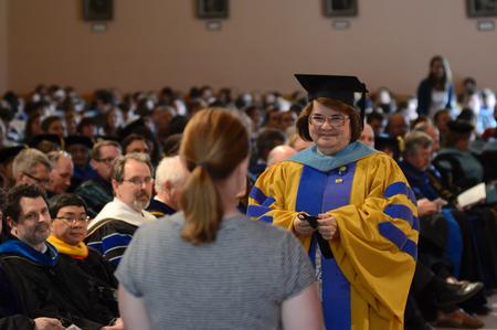 Janet Furness, associate dean of social work, presents the Academic Excellence Medal to Bri Hansen, senior social work major, during the annual Awards Day chapel service. - Photo by Jacob Moore