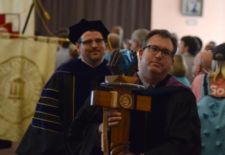 Gavin Richardson, professor of English and recipient of the 2012 Faculty of the Year award, leads the faculty procession out of chapel. - Photo by Jacob Moore