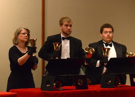 Susan Bolyard, secretary for the McAfee School of Business Administration, Christian Wallen, senior chemistry major, and Cedric Townsend, freshman music major, perform with the Handbell Choir at Luther Hall. - Photo by Jacob Moore