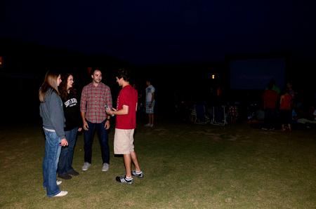 Sara Beth Byars, junior elementary education major, Courtney Olson, junior English major, Trey Collier, business administration graduate student, and Jonathan Boyd, senior chemistry major, chat prior to SAC's Movie on the Lawn, where Sherlock Holmes 2 was shown. - Photo by Anne Richoux