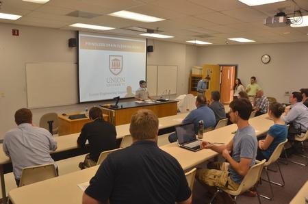 Professor of Engineering and Department Chair Don Van welcomes guest to the Senior Engineering Capstone Project. - Photo by Morris Abernathy