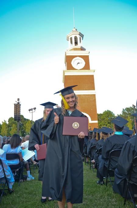 Cassie Hallmark, elementary education graduate, gives a thumbs up after receiving her diploma during spring graduation on the Great Lawn. 
 - Photo by Zac Calvert