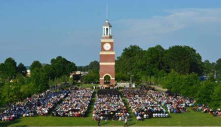 A large crowd of friends and family gather with graduates for spring graduation. - Photo by Morris Abernathy