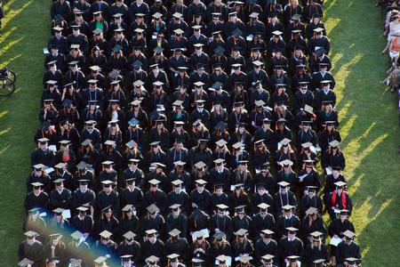 614 excited graduates wait to receive their diplomas during spring graduation on a gorgeous summer evening.  - Photo by Kristi McMurry Woody