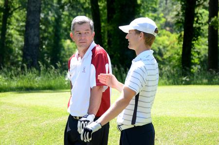 Andy Rushing, head golf coach, chats with Brett Barry, junior, on the golf course.  - Photo by Zac Calvert