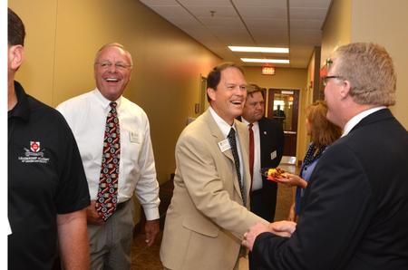 Tony Wamble, laboratory specialist, Gary Carter, senior vice president for business services, and Tim Smith, dean of the school of nursing, greet each other at the dedication ceremony for the new Hendersonville facility. - Photo by Morris Abernathy