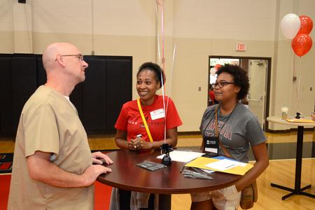 Paul Mayer, director of health services, talks with Paula Akerson and Ashley Akerson, freshman art and Christian ministry and missions double major, during new student move-in day. - Photo by Jacob Moore