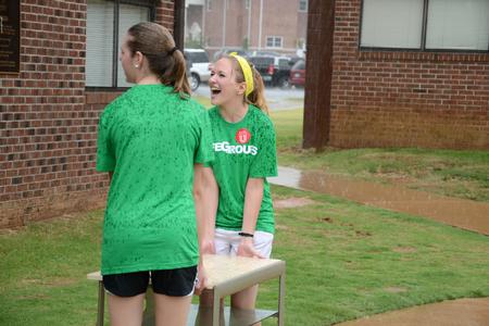 Kendall Heyliger, sophomore nursing major, helps carry a desk through the rain during new student move-in day. - Photo by Jacob Moore