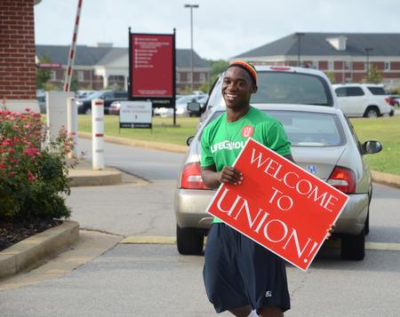 Josh Jenkins, sophomore Christian studies major, welcomes new students as the residence complexes open for the Fall 2012 semester.  - Photo by Ebbie Davis